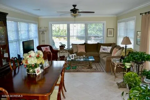 a living room with furniture floor to ceiling window and a fireplace