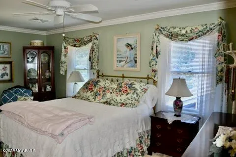 a bed room with a bed mirror and wall paintings