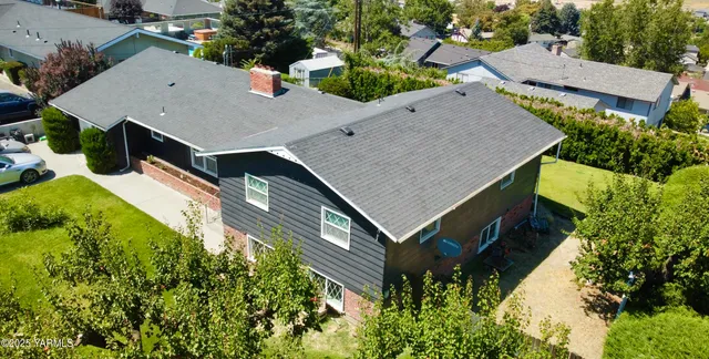 an aerial view of a house with a yard and potted plants