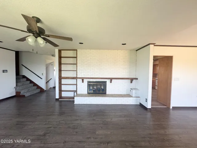 a view of a room with wooden floor garage and window