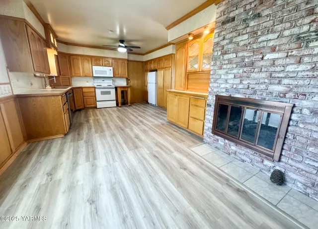 a kitchen view with wooden floor and outdoor space