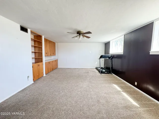 a big room with closet and wooden floor