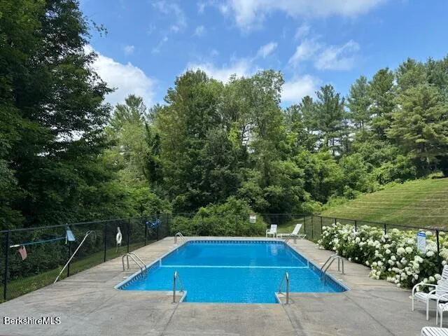 a view of swimming pool with a yard