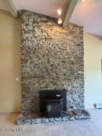 a bathroom with a shower and a tiled wall