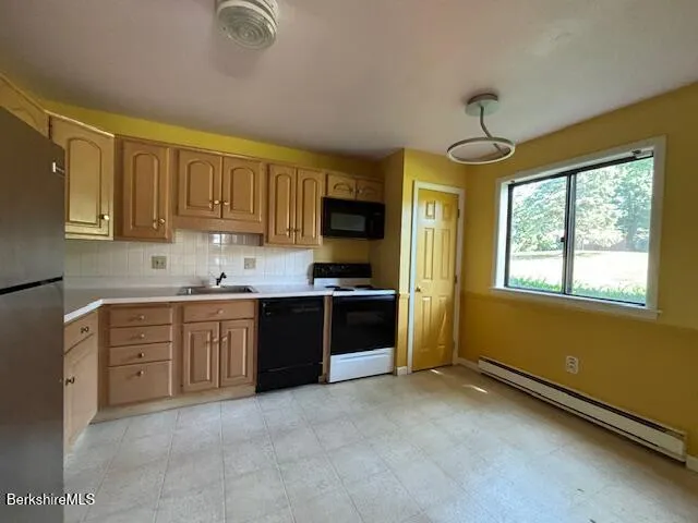 a kitchen with granite countertop a stove cabinets and a sink