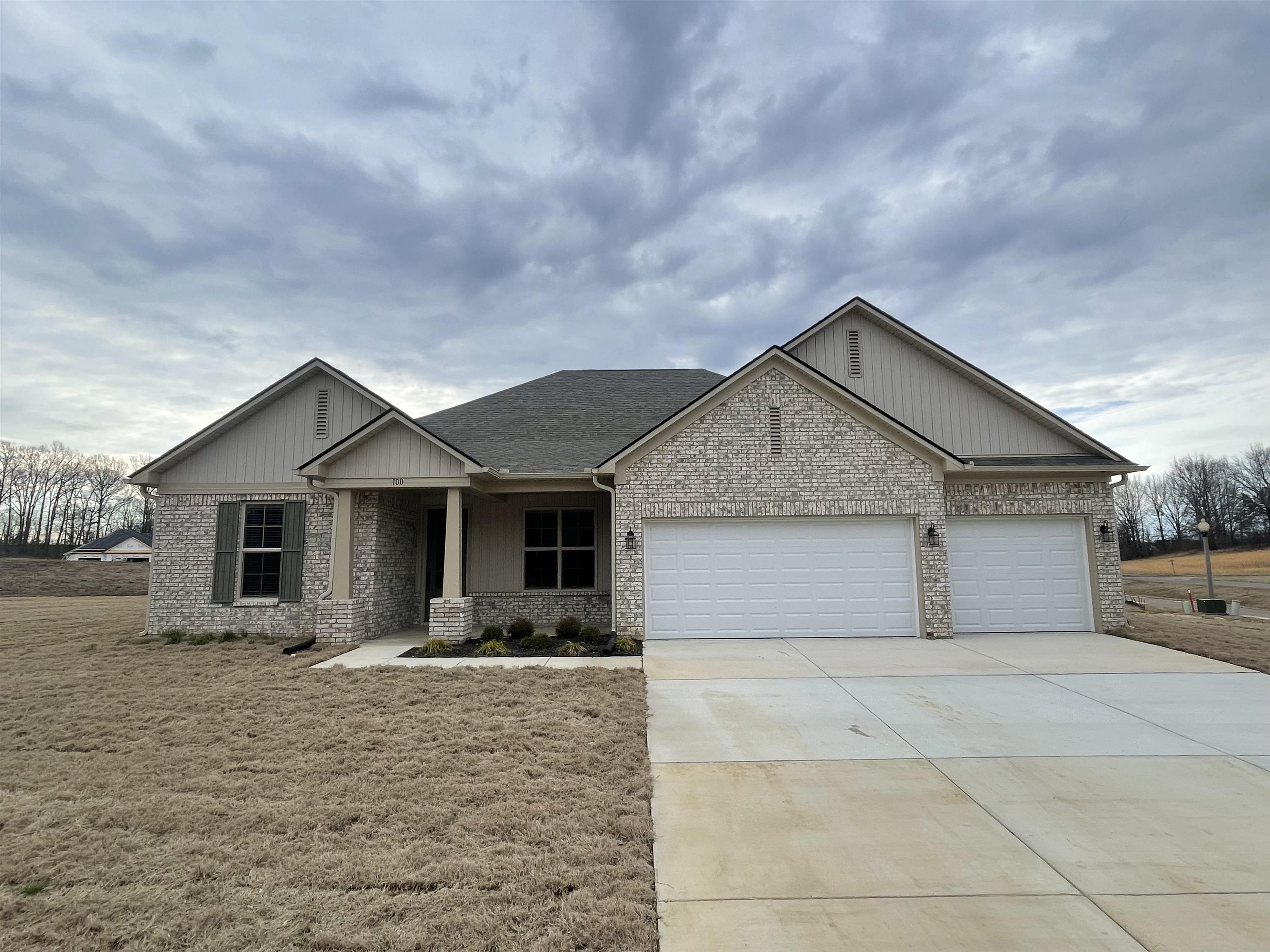 a front view of house with yard and trees