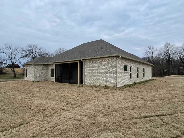 a front view of house with yard and trees