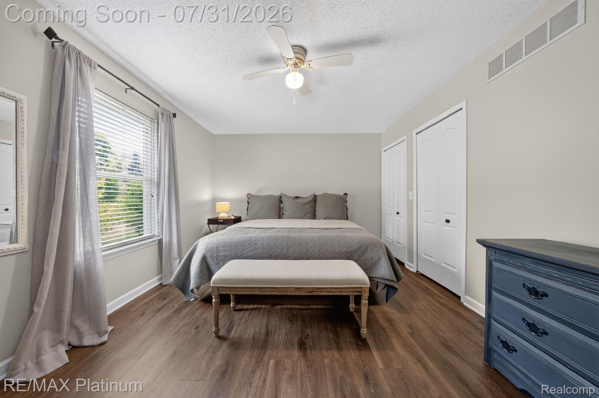 2401 Golf Club Road Howell, MI 48843 - Photo 11 of 37 Spacious room featuring wood-finish flooring, a ceiling fan, and a large window with blinds
