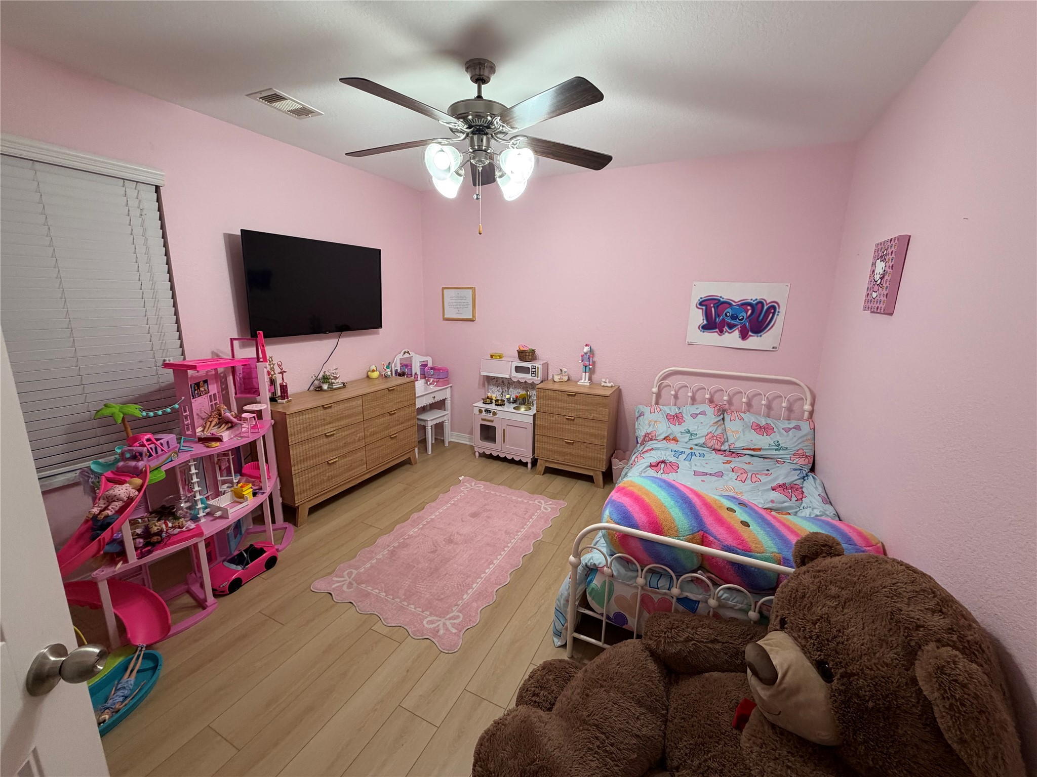 28987 Birch Green Way Spring, TX 77386 - Photo 21 of 32 a bedroom with furniture and a flat screen tv