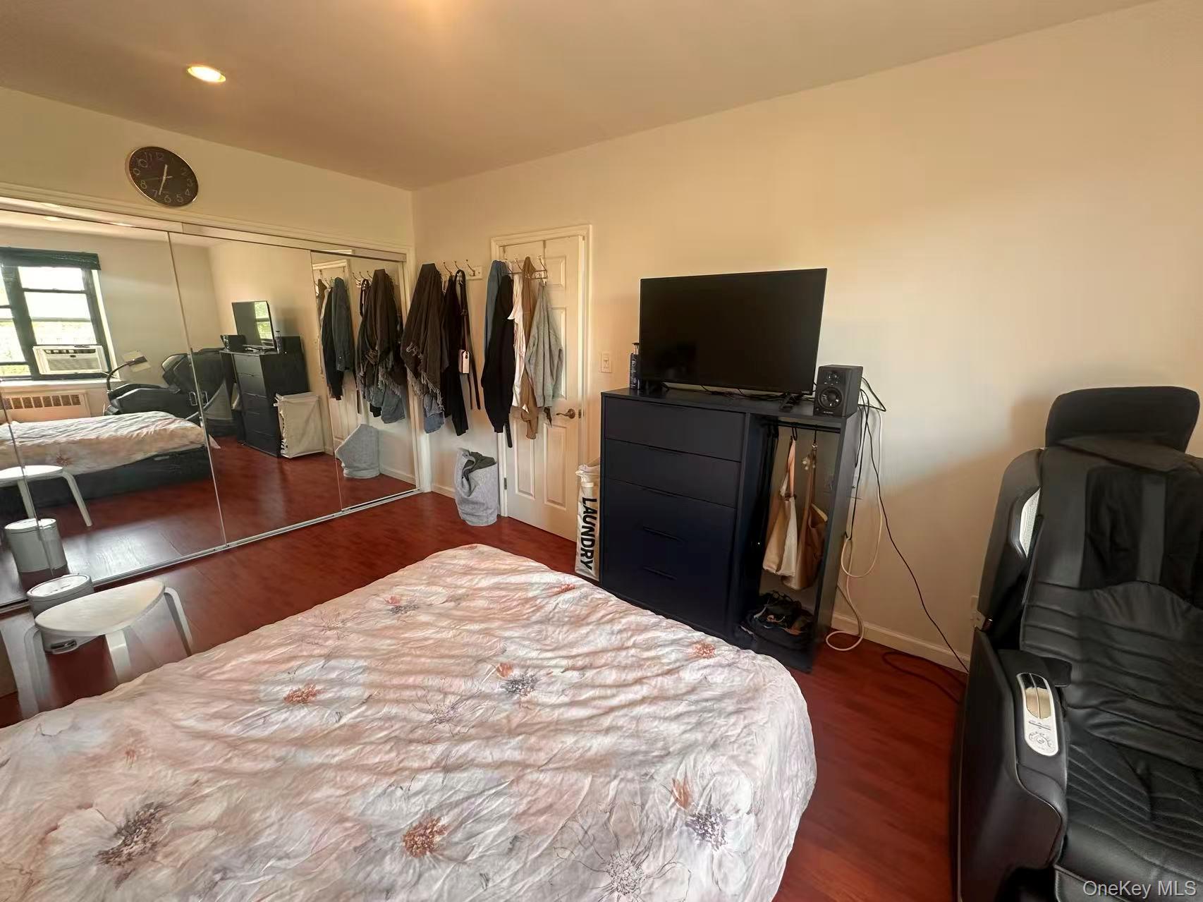 139-15 28th Road, Unit 6G Queens, NY 11354 - Photo 14 of 20 a bedroom with a bed and a flat screen tv