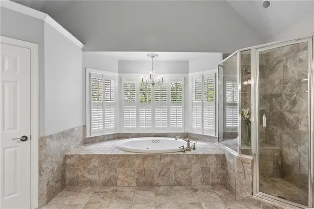 a bathroom with a tub and shower