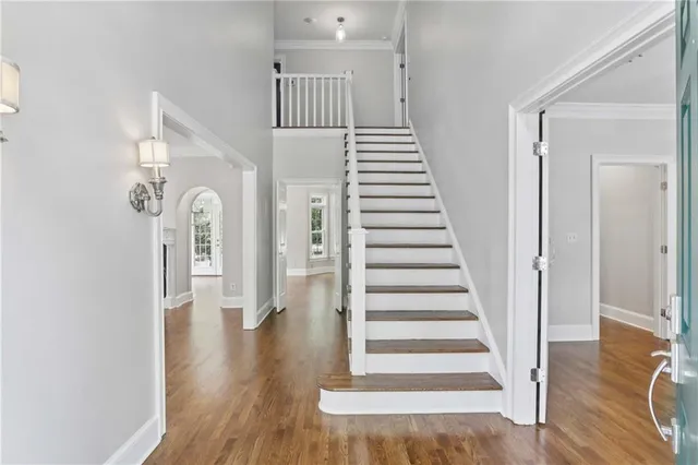 a view of entryway and hall with wooden floor
