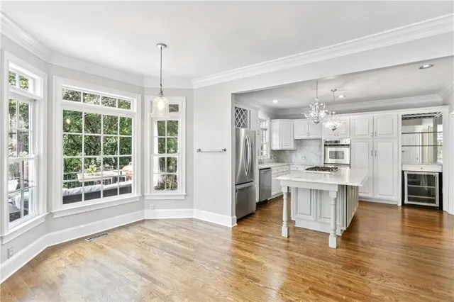 a open kitchen with granite countertop a refrigerator stove top oven and sink