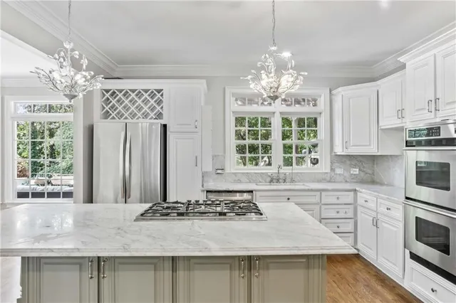 a kitchen with kitchen island granite countertop a sink and cabinets