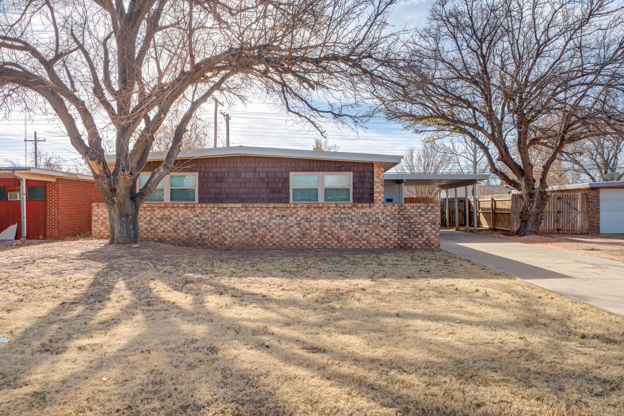 2803 66th Street Lubbock, TX 79413 - Photo 1 of 23 a view of a house with a yard covered in snow
