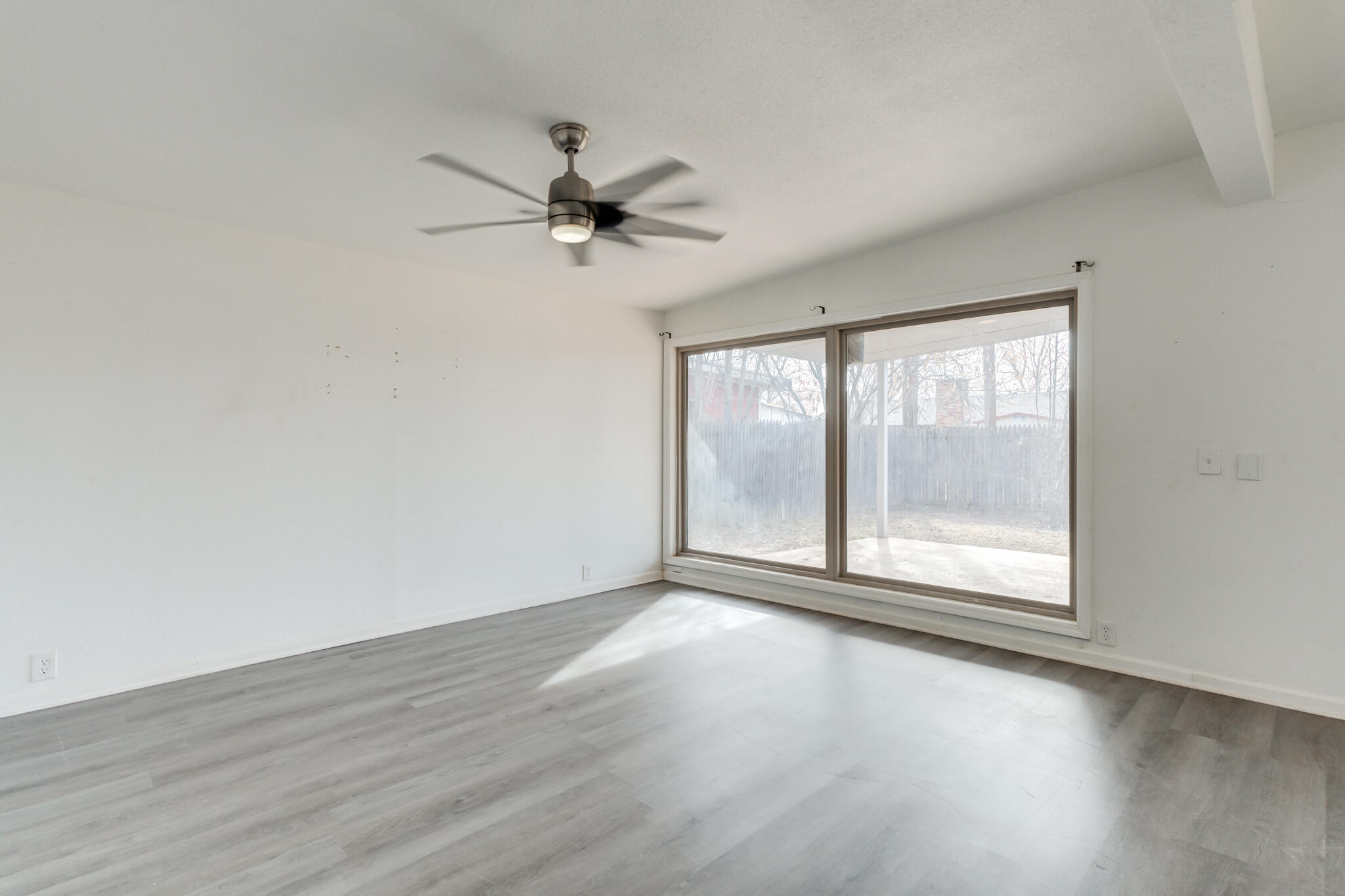 2803 66th Street Lubbock, TX 79413 - Photo 11 of 23 an empty room with wooden floor and windows