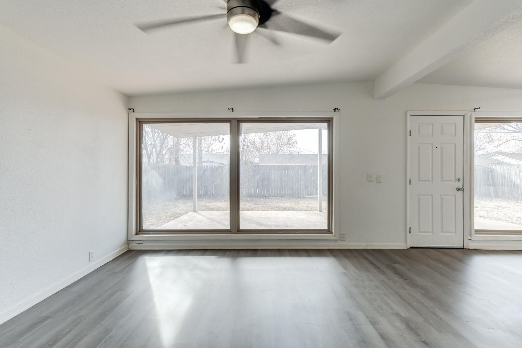 2803 66th Street Lubbock, TX 79413 - Photo 13 of 23 an empty room with wooden floor and windows