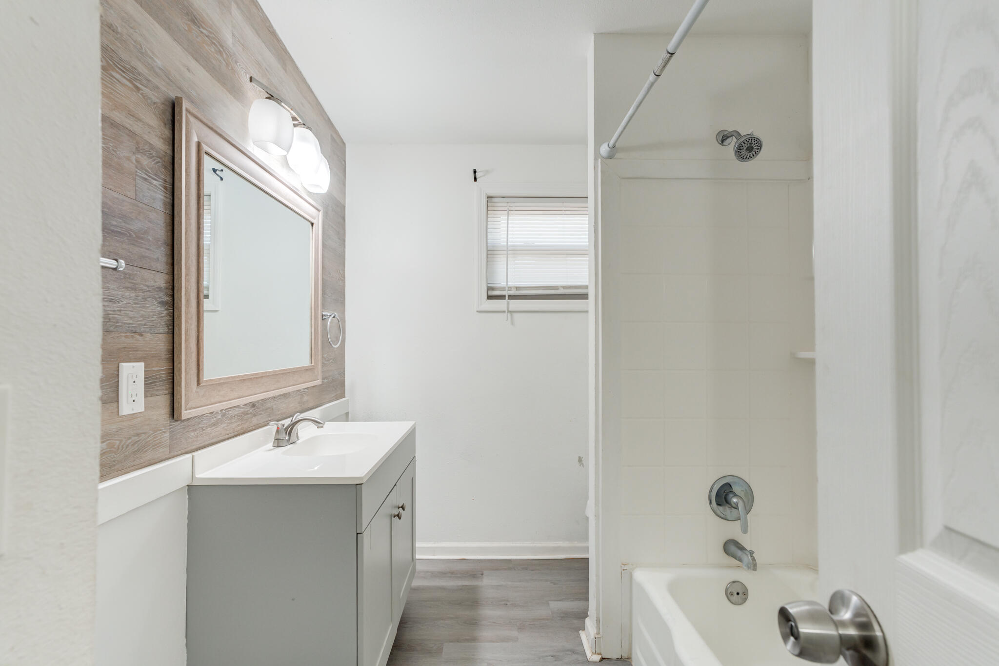 2803 66th Street Lubbock, TX 79413 - Photo 15 of 23 a bathroom with a tub sink and mirror