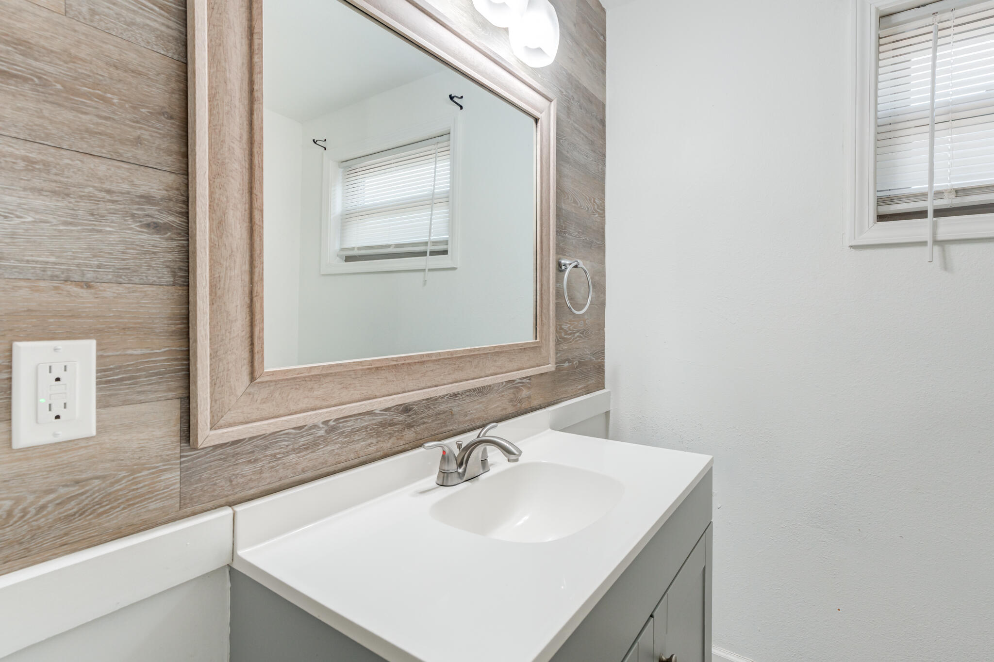 2803 66th Street Lubbock, TX 79413 - Photo 16 of 23 a bathroom with a sink and a mirror
