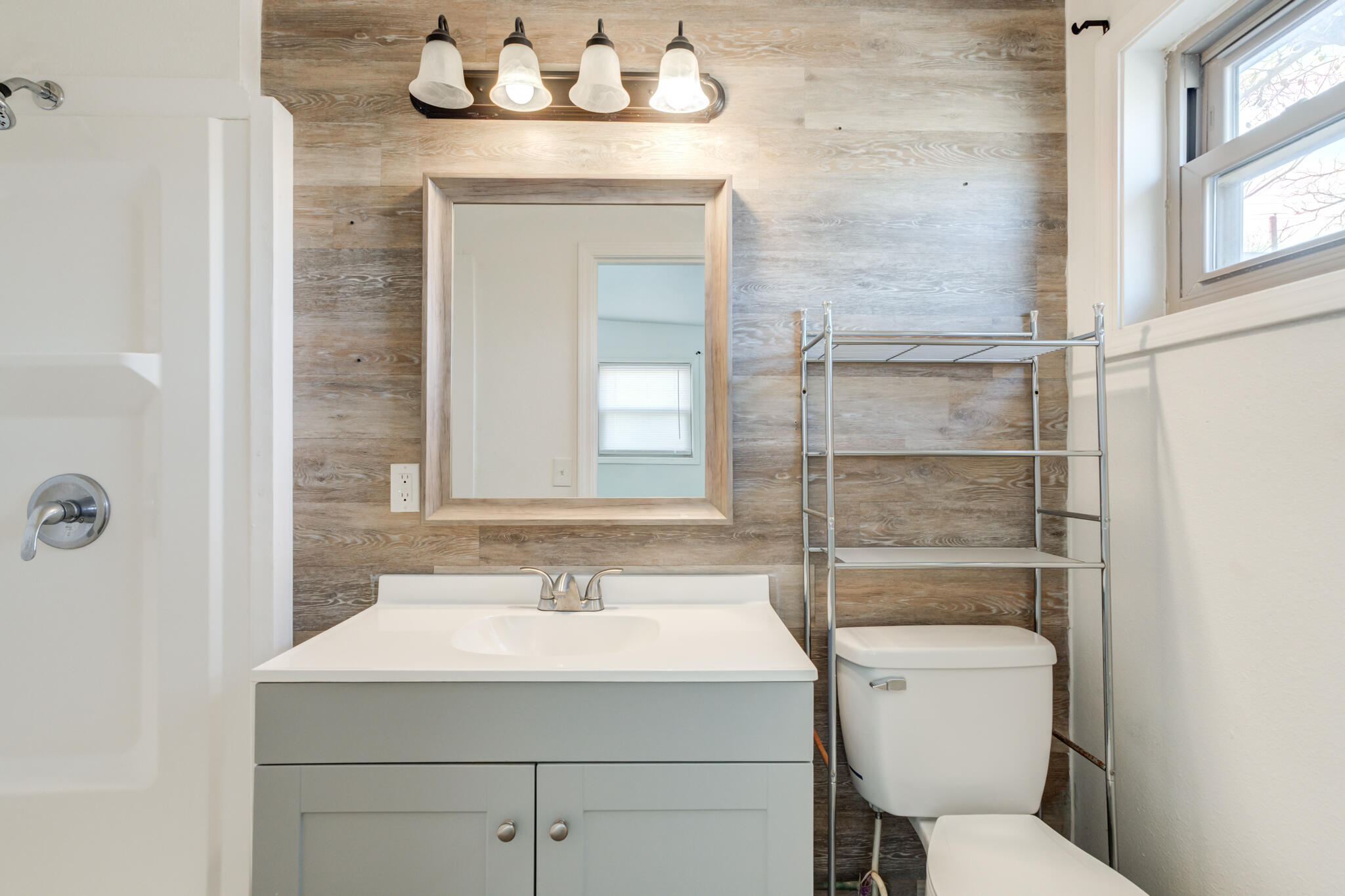 2803 66th Street Lubbock, TX 79413 - Photo 17 of 23 a bathroom with a sink toilet and mirror