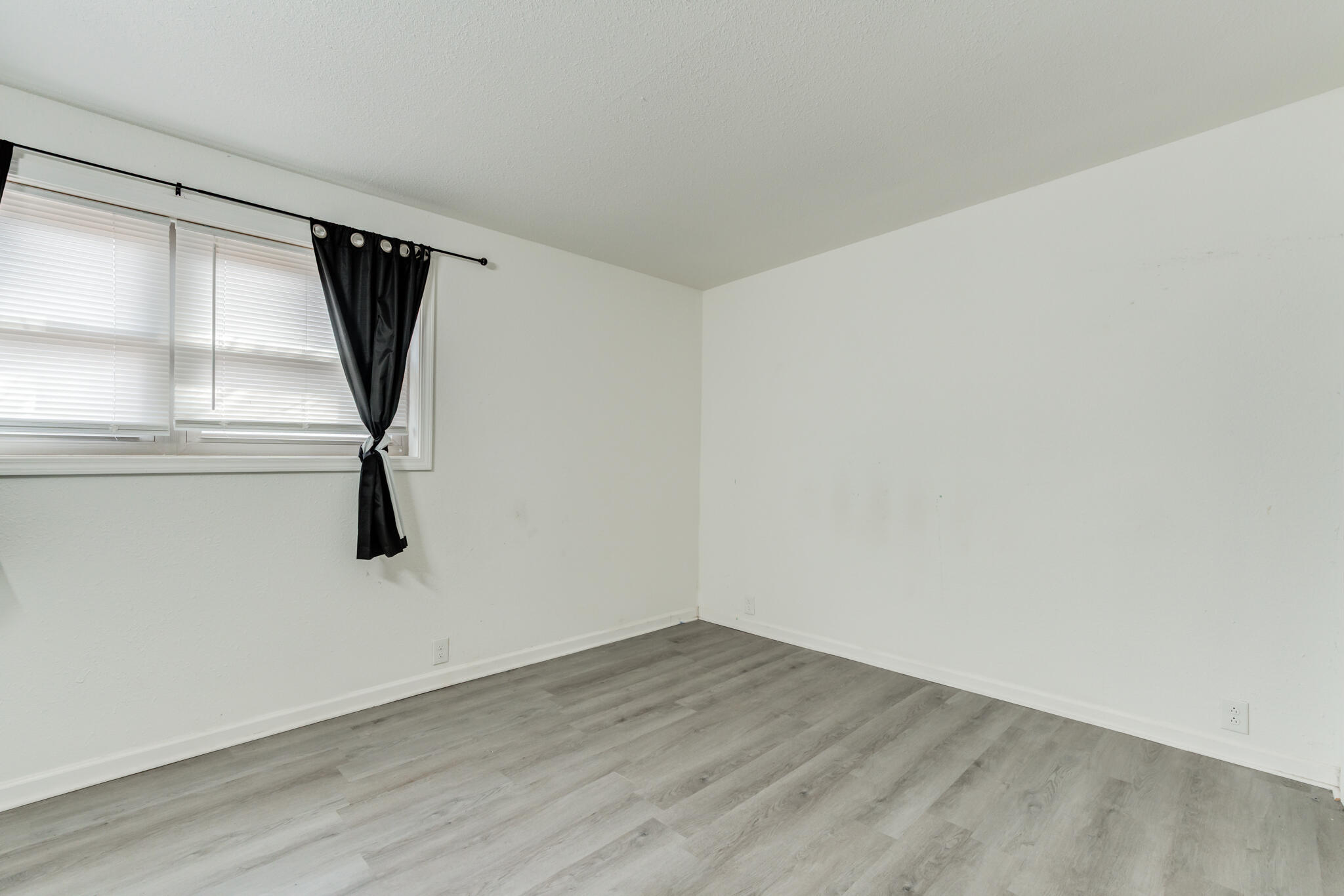 2803 66th Street Lubbock, TX 79413 - Photo 18 of 23 a view of a room with wooden floor and window