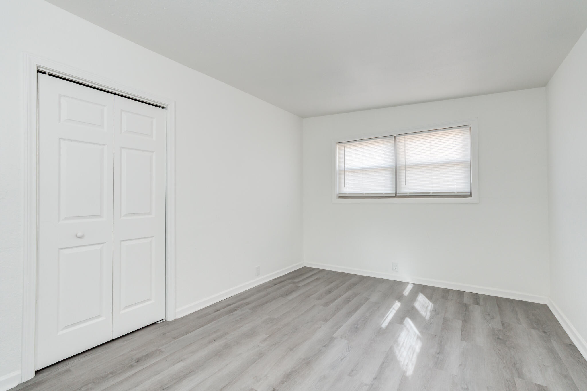 2803 66th Street Lubbock, TX 79413 - Photo 20 of 23 an empty room with wooden floor and a window