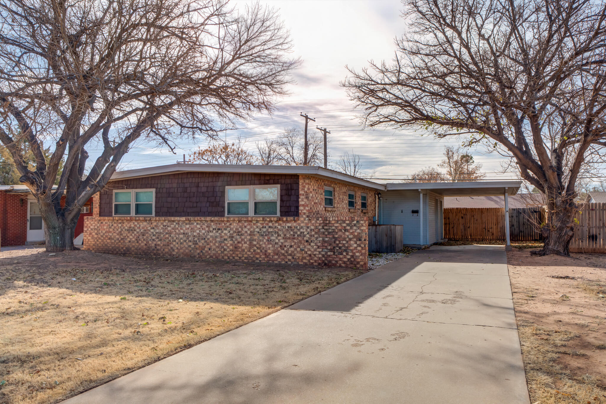 2803 66th Street Lubbock, TX 79413 - Photo 2 of 23 a front view of a house with a yard covered in snow