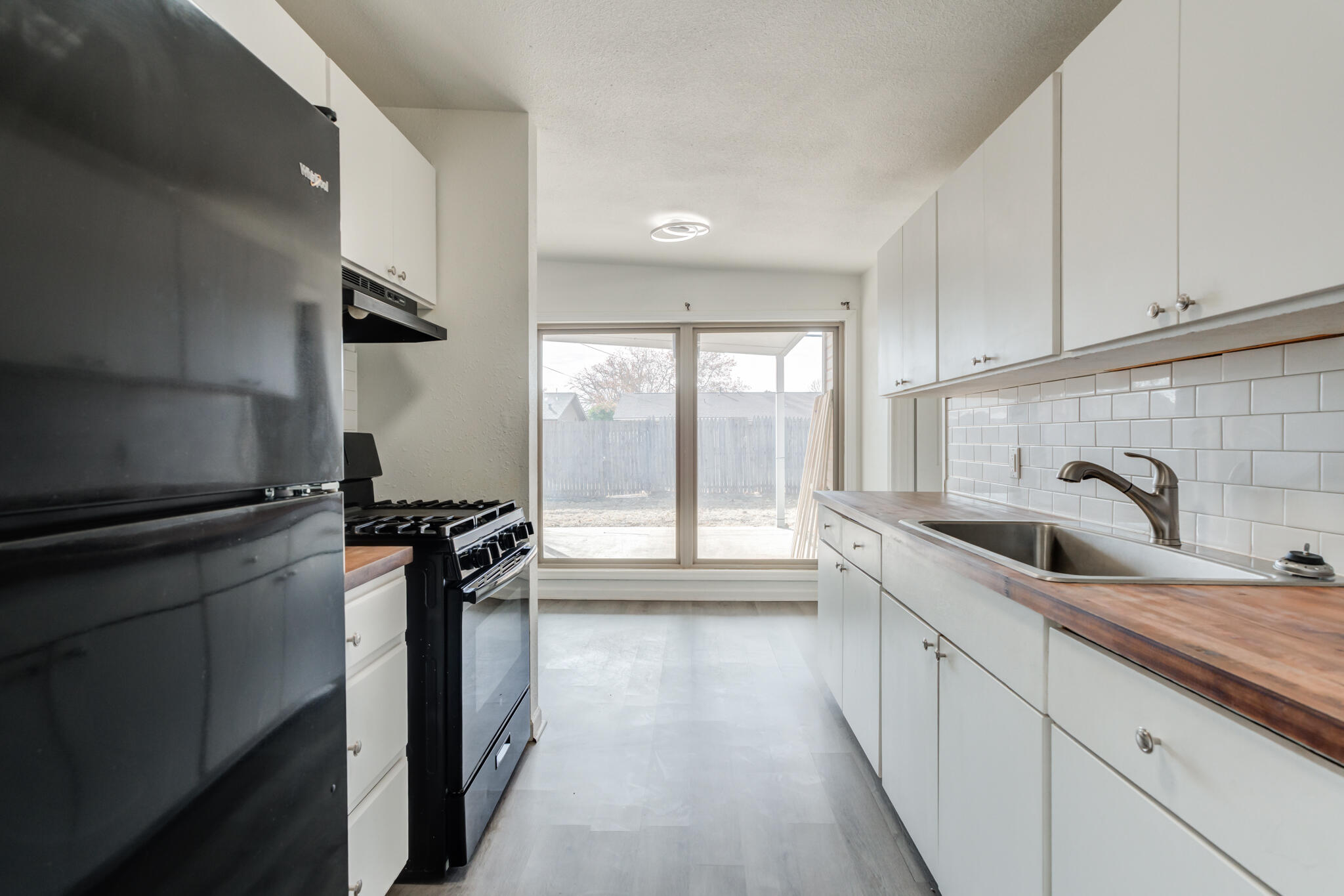 2803 66th Street Lubbock, TX 79413 - Photo 6 of 23 a kitchen with stainless steel appliances a sink stove and cabinets