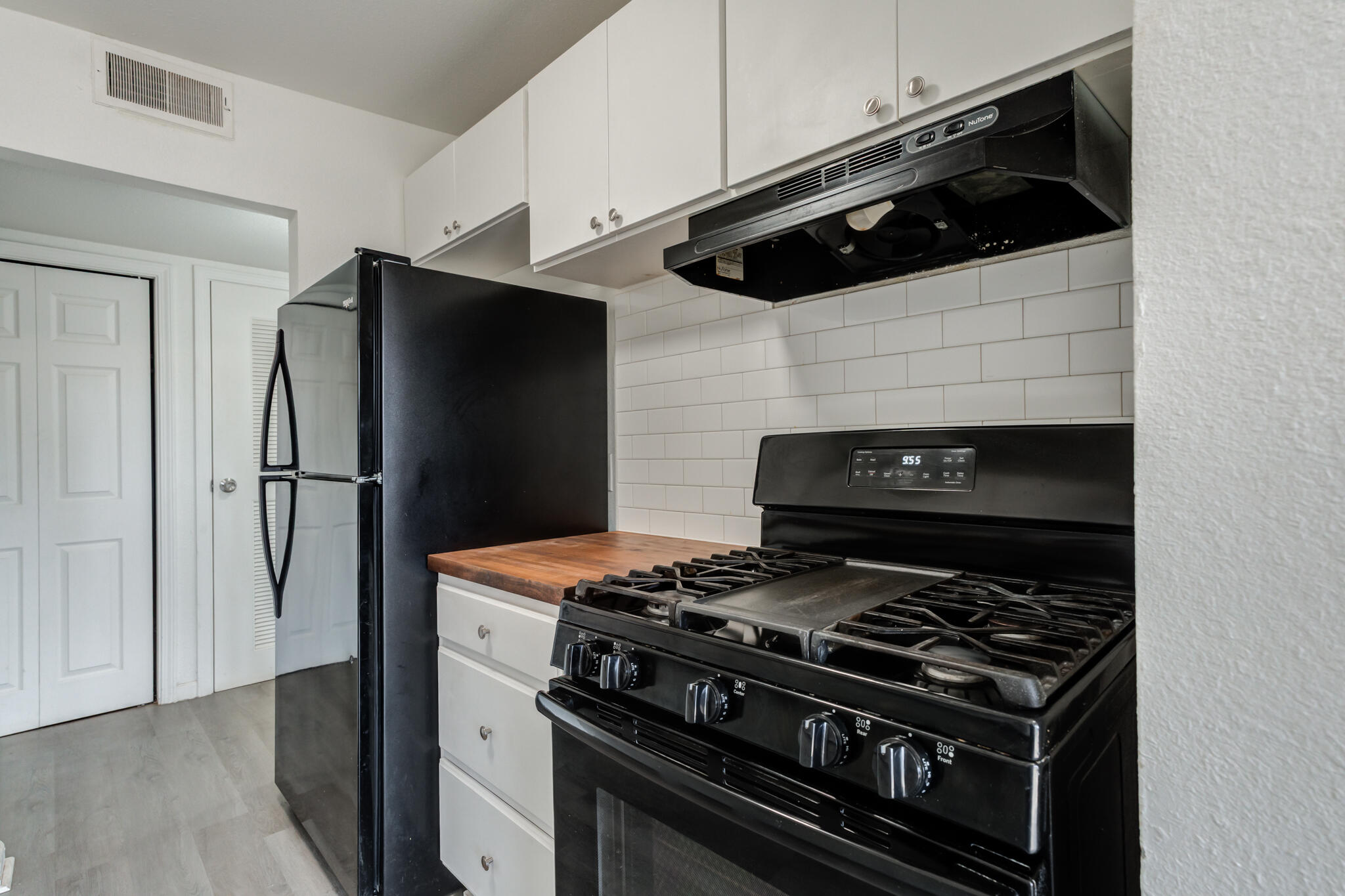 2803 66th Street Lubbock, TX 79413 - Photo 7 of 23 a kitchen with a stove and a refrigerator