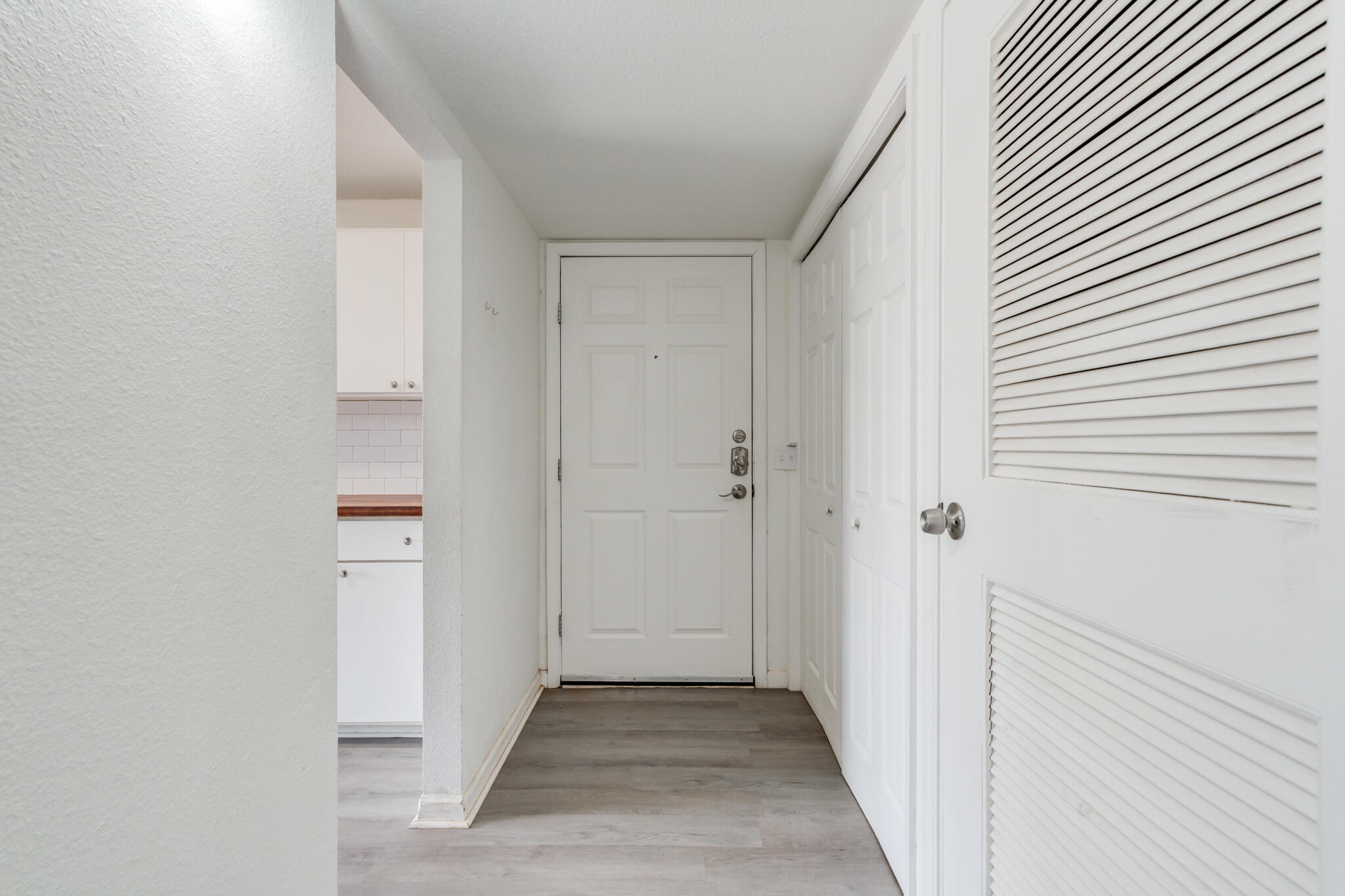 2803 66th Street Lubbock, TX 79413 - Photo 9 of 23 a view of a hallway with wooden floor
