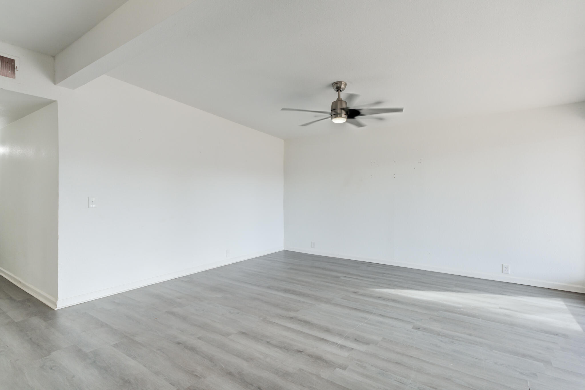 2803 66th Street Lubbock, TX 79413 - Photo 10 of 23 a view of a room with wooden floor and a ceiling fan