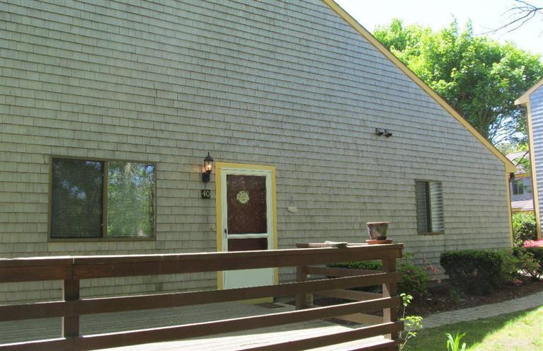 a view of a house with a door and a yard