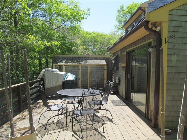 40 Round House Road, Unit 40 Bourne, MA 02532 - Photo 3 of 5 a patio with table and chairs and potted plants