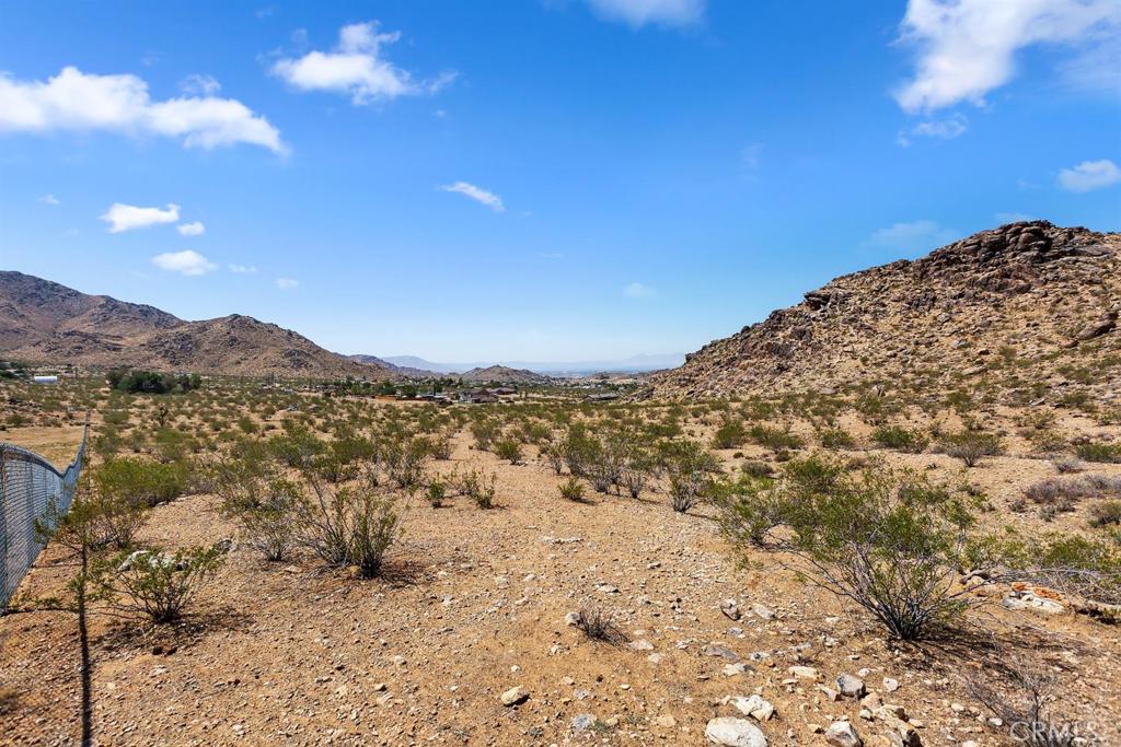 0 Clark Drive Apple Valley, CA 92307 - Photo 13 of 14 a view of a dry yard with mountains in the background