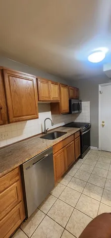 a kitchen with stainless steel appliances granite countertop a sink and a stove