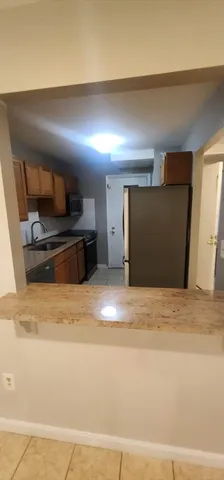 a view of a livingroom with an empty space and a sink