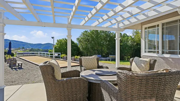 a view of a chairs and table in patio