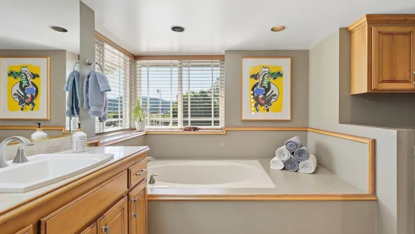 a bathroom with a sink a toilet and shower curtain