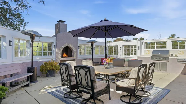 a view of a house with backyard porch and sitting area