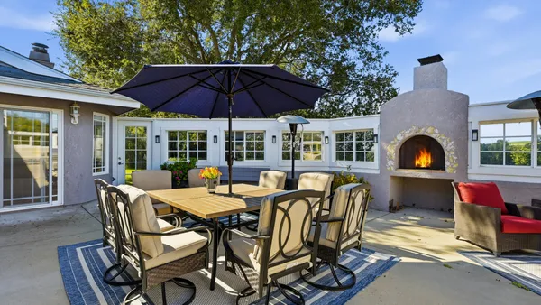 a view of a house with couches in a patio