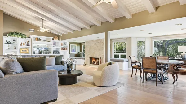 a living room with furniture and a painting