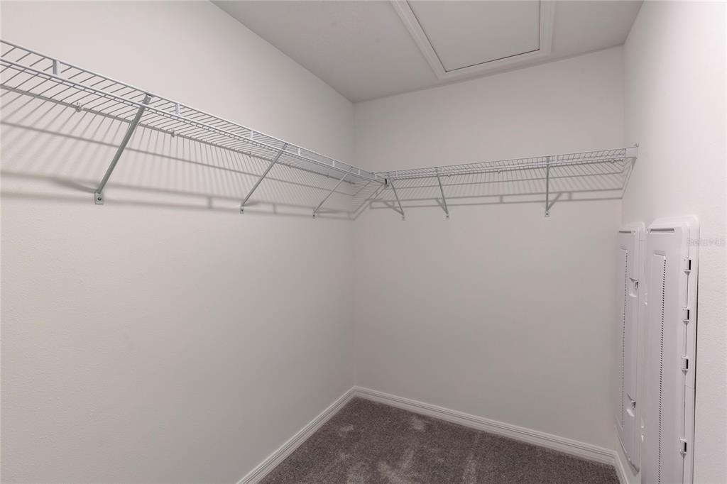 11091 Wishing Cloud Road Land O Lakes, FL 34638 - Photo 13 of 25 a view of a room with racks on the wall