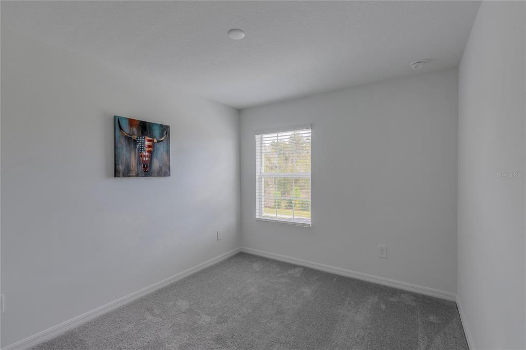 11091 Wishing Cloud Road Land O Lakes, FL 34638 - Photo 17 of 25 an empty room with a window