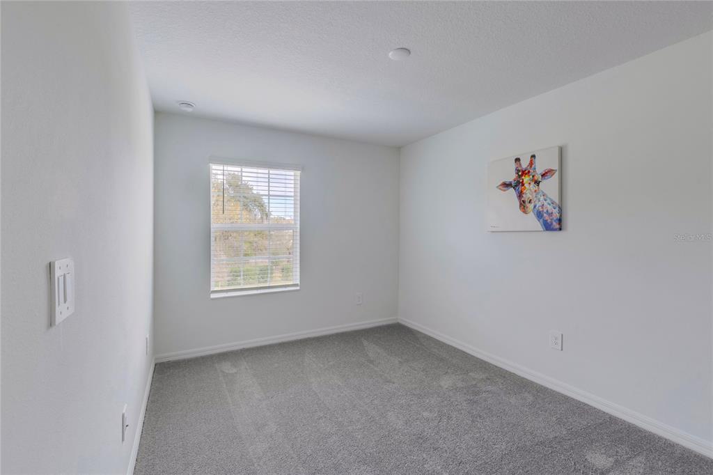 11091 Wishing Cloud Road Land O Lakes, FL 34638 - Photo 19 of 25 an empty room with a window