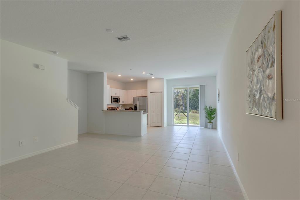 11091 Wishing Cloud Road Land O Lakes, FL 34638 - Photo 2 of 25 a view of a big room with windows and chandelier