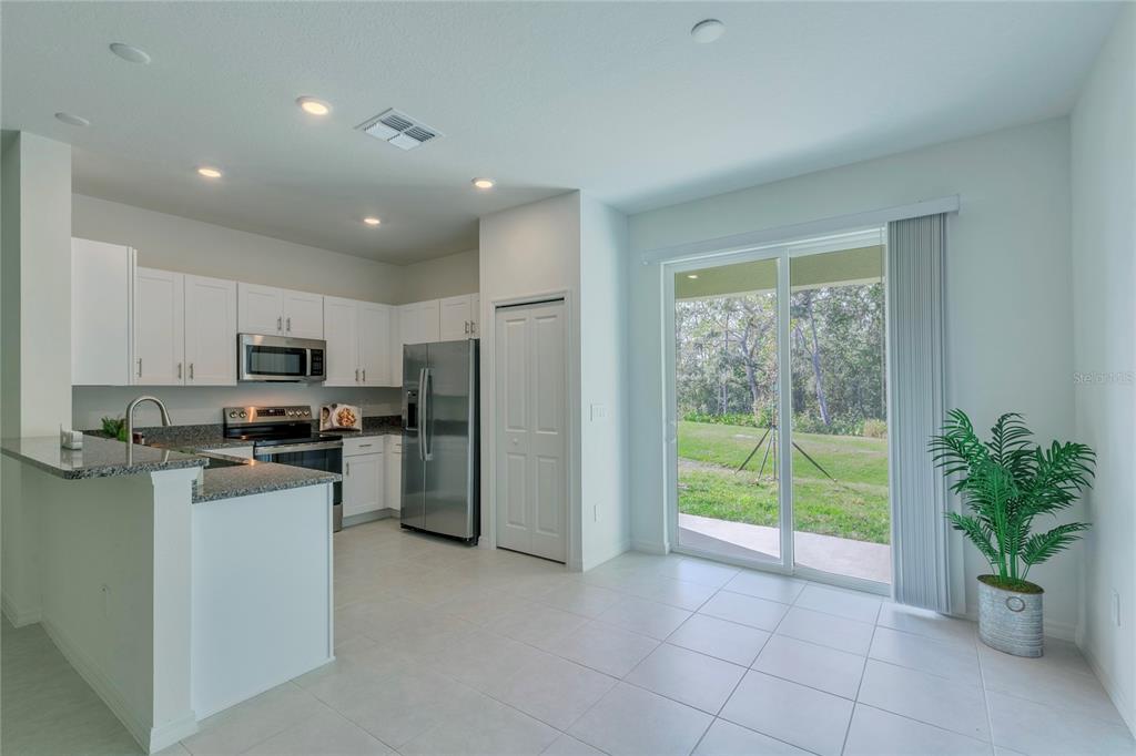 11091 Wishing Cloud Road Land O Lakes, FL 34638 - Photo 7 of 25 a kitchen with a refrigerator and a sink
