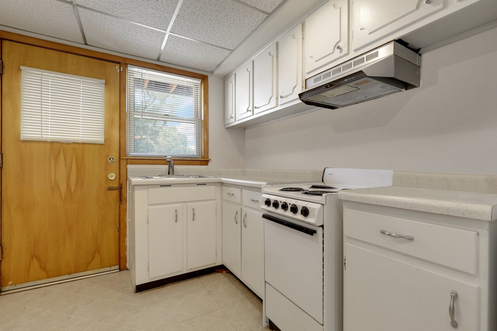 11907 Gregory Street, Unit 3 Blue Island, IL 60406 - Photo 7 of 17 a kitchen with stainless steel appliances granite countertop white cabinets and a stove