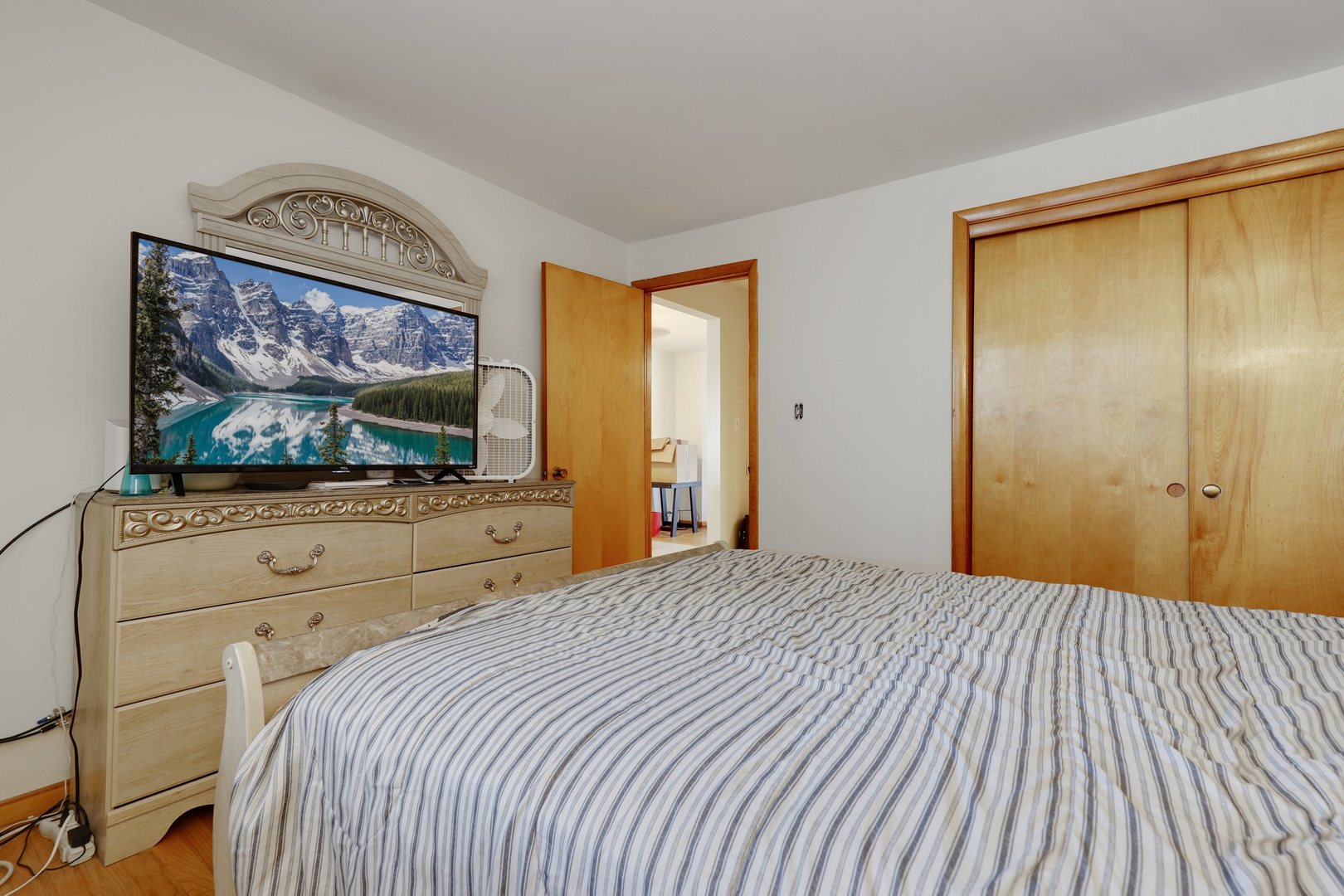 11907 Gregory Street, Unit 3 Blue Island, IL 60406 - Photo 9 of 17 a bedroom with a bed and a flat screen tv