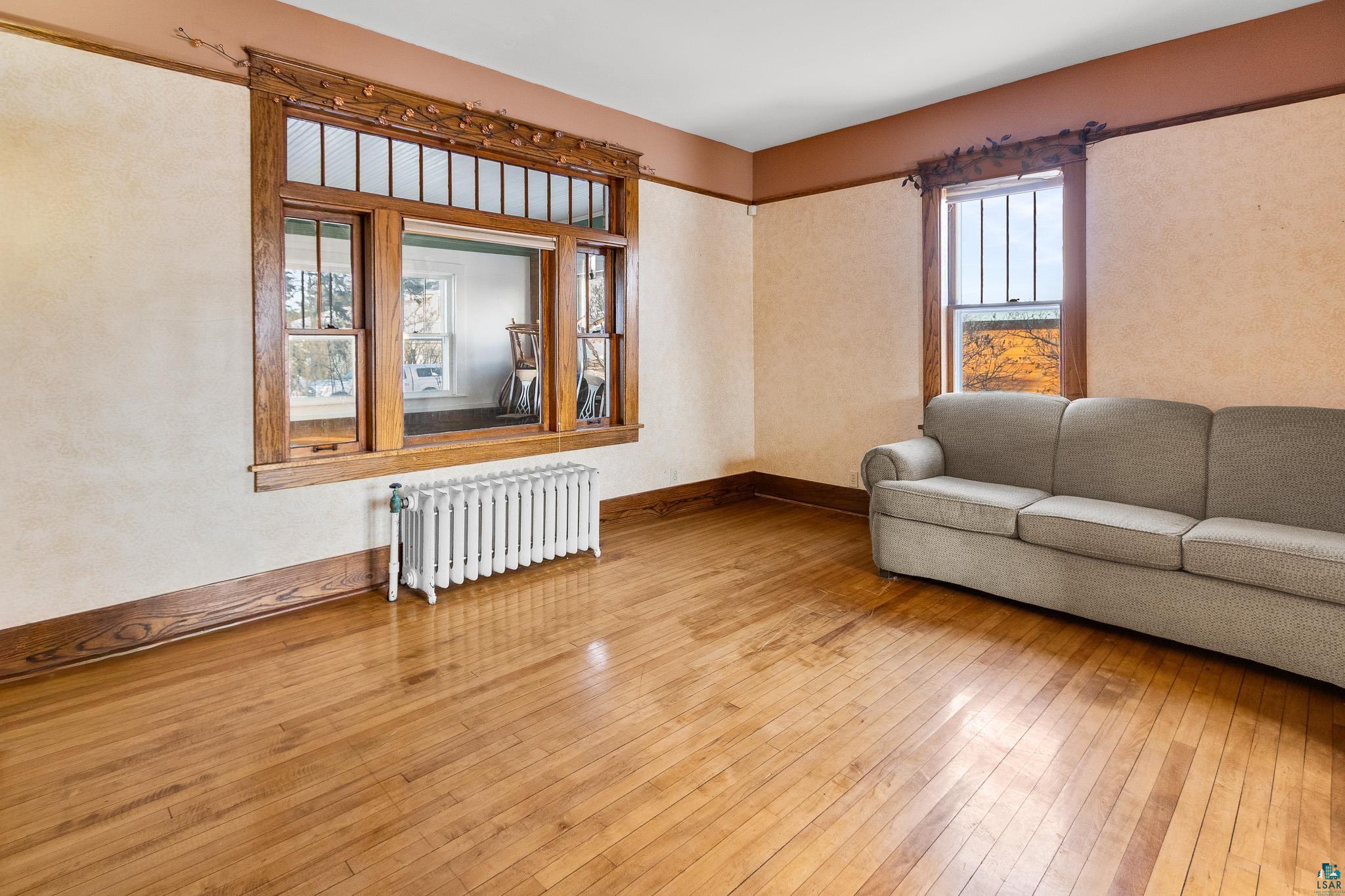 6494 School Street Finlayson, MN 55735 - Photo 9 of 31 Living room with radiator and hardwood / wood-style floors