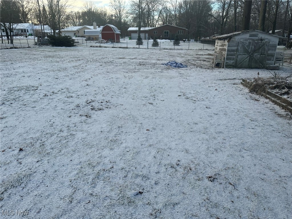 97 West Howe Road Tallmadge, OH 44278 - Photo 3 of 35 Yard covered in snow with a storage unit